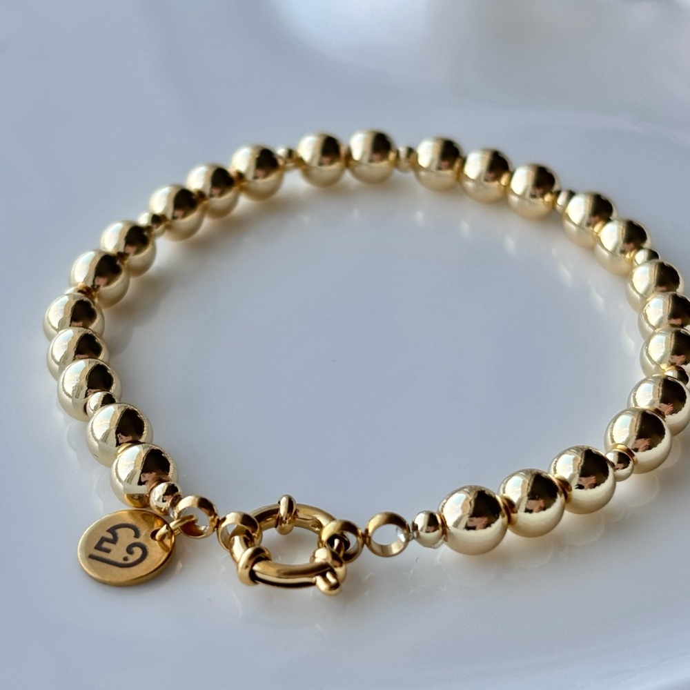 Gold Beaded Bracelet with Signature Charm